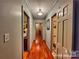 Hallway featuring hardwood floors, neutral walls, and decorative light fixture at 1359 Carmen Ln, Gastonia, NC 28054