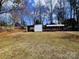 Spacious backyard with an outbuilding and covered carport, with mature trees, great for storage at 1377 S Aspen St, Lincolnton, NC 28092