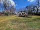 Fenced backyard offering a secure space with access to a deck and lush greenery at 1377 S Aspen St, Lincolnton, NC 28092