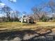 Quaint single-story home featuring a charming front porch and mature trees in a spacious yard at 1377 S Aspen St, Lincolnton, NC 28092