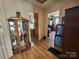 Inviting hallway with hardwood floors, connecting to the bedroom and kitchen, with a glass display case at 1377 S Aspen St, Lincolnton, NC 28092