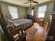 Bright primary bedroom showcasing hardwood floors and a view of the front yard through large windows at 1377 S Aspen St, Lincolnton, NC 28092