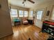 Bright sunroom features laminate floors, a pink accent chair, and natural lighting at 1377 S Aspen St, Lincolnton, NC 28092