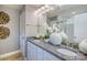 Elegant bathroom features double sinks, granite countertops, a decorative mirror and a glass-enclosed shower at 13935 Penbury Ln # 378, Charlotte, NC 28278