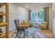 Inviting home office featuring natural light, paneled walls, and comfortable seating for productivity at 13935 Penbury Ln # 378, Charlotte, NC 28278