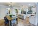 Open kitchen and dining area with stainless steel appliances and an island with barstool seating at 13935 Penbury Ln # 378, Charlotte, NC 28278