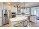 Contemporary kitchen featuring stainless steel appliances, white cabinets, and breakfast bar seating for casual dining at 13935 Penbury Ln # 378, Charlotte, NC 28278