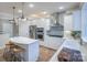 Modern kitchen with stainless steel appliances, a spacious island, and sleek white cabinetry at 13935 Penbury Ln # 378, Charlotte, NC 28278
