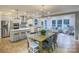 Open-concept living space with modern kitchen, dining area, and cozy living room featuring large windows at 13935 Penbury Ln # 378, Charlotte, NC 28278