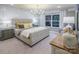 Inviting main bedroom with a large upholstered bed, a nightstand, and a bright window view at 13935 Penbury Ln # 378, Charlotte, NC 28278