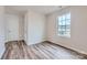 Well-lit bedroom features wood floors and a window overlooking the quiet street at 1402 Pine Heart Dr, Edgemoor, SC 29712