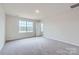 Neutral bedroom showcasing a large window providing ample natural light and plush gray carpeting at 1402 Pine Heart Dr, Edgemoor, SC 29712