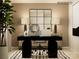 Modern home office featuring a sleek black desk and a stylish mirror above the console table at 1402 Pine Heart Dr, Edgemoor, SC 29712