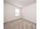 Bright, carpeted bedroom with neutral walls and natural light streaming through the window, creating a serene atmosphere at 167 Shepherds Landing Dr, Mooresville, NC 28115