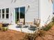 A charming patio with wicker chairs and a table outside a home with white siding at 168 Shepherds Landing Dr, Mooresville, NC 28115