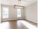 Dining room with stylish light fixture, wood-look flooring, and large windows at 1770 Windsor Dr, Lancaster, SC 29720