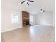 Bright living room with vaulted ceiling, brick fireplace, ceiling fans, and wood-look flooring at 1770 Windsor Dr, Lancaster, SC 29720