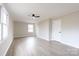 Bright living room with updated flooring, modern ceiling fan, and lots of natural light at 1770 Windsor Dr, Lancaster, SC 29720