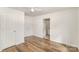 Bedroom with wood-look floors, ceiling fan, and adjacent bathroom doorway at 1893 Hilltop Cir, Gastonia, NC 28054