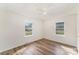 Bright bedroom with neutral walls, wood-look flooring, and two windows offering natural light at 1893 Hilltop Cir, Gastonia, NC 28054