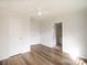 Bedroom with wood-look flooring, ceiling fan, and closet doors at 1893 Hilltop Cir, Gastonia, NC 28054