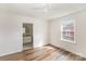 Bedroom with wood-look floors, a ceiling fan, and an adjacent bathroom at 1893 Hilltop Cir, Gastonia, NC 28054