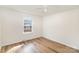 Clean bedroom featuring wood-look floors and a window providing natural light at 1893 Hilltop Cir, Gastonia, NC 28054