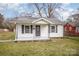 Traditional-style home featuring a covered front porch with supporting columns at 1893 Hilltop Cir, Gastonia, NC 28054