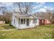 Inviting one-story home featuring a covered front porch and well-maintained lawn at 1893 Hilltop Cir, Gastonia, NC 28054