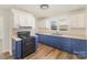 Bright kitchen featuring two-tone cabinets, stone backsplash, and ample natural light at 1893 Hilltop Cir, Gastonia, NC 28054