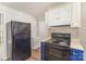 Kitchen area featuring modern appliances and wood-look flooring, great functionality at 1893 Hilltop Cir, Gastonia, NC 28054