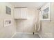 Laundry area featuring utility connections, storage cabinets, and a window at 1893 Hilltop Cir, Gastonia, NC 28054