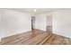 Minimalist room with vinyl flooring, light walls, and an open doorway at 1893 Hilltop Cir, Gastonia, NC 28054