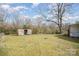 View of shed in a spacious backyard with lush green grass at 1893 Hilltop Cir, Gastonia, NC 28054