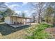 View of the backyard, featuring a covered patio with outdoor seating and a well-maintained lawn at 1911 Woodlawn St, Kannapolis, NC 28083