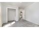 This bedroom has gray walls, gray carpet, a closet, and a doorway to the kitchen at 1911 Woodlawn St, Kannapolis, NC 28083