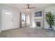 Inviting living room with gray-painted fireplace, neutral carpet, and ample natural light at 1911 Woodlawn St, Kannapolis, NC 28083