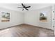 Bedroom featuring wood-look floors, two windows and a ceiling fan at 1915 Kingston Dr, Gastonia, NC 28052