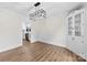 Dining room featuring wood floors, built-in cabinet, and view of the modern kitchen at 1915 Kingston Dr, Gastonia, NC 28052