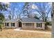 Charming brick home with a well-manicured lawn and inviting walkway leading to the front door at 1915 Kingston Dr, Gastonia, NC 28052