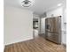 Bright kitchen featuring stainless steel refrigerator, white cabinets, and wood-look flooring at 1915 Kingston Dr, Gastonia, NC 28052