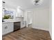 Modern kitchen with stainless steel appliances, sleek white cabinets, and wood-look flooring at 1915 Kingston Dr, Gastonia, NC 28052