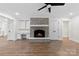 Living room boasts a brick fireplace, wood-look flooring and built in shelving at 1915 Kingston Dr, Gastonia, NC 28052