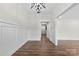 Bright living room featuring wood floors, white wainscoting, and a modern light fixture at 1915 Kingston Dr, Gastonia, NC 28052