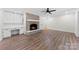 Cozy living room featuring brick fireplace, built-in shelving, and wood-look flooring at 1915 Kingston Dr, Gastonia, NC 28052