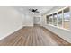 Bright living room featuring wood floors, white walls, and a modern light fixture at 1915 Kingston Dr, Gastonia, NC 28052