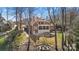 Aerial view of the property showcasing the pool, fire pit, and spacious backyard in a tranquil, wooded setting at 20338 Christofle Dr, Cornelius, NC 28031