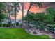 Relaxing backyard fire pit area perfect for entertaining, with serene lake views and colorful sunset at 20338 Christofle Dr, Cornelius, NC 28031