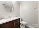 Contemporary bathroom features a large mirror, dark vanity, and modern fixtures at 20338 Christofle Dr, Cornelius, NC 28031