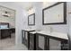 Stylish bathroom with double vanities, framed mirrors, and modern fixtures at 20338 Christofle Dr, Cornelius, NC 28031